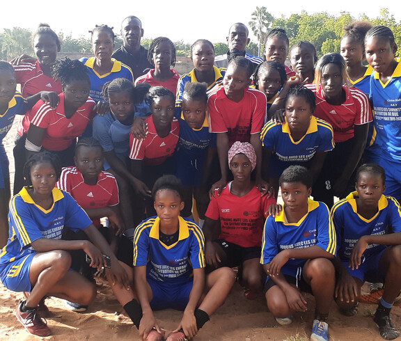 In Mali ist es bemerkenswert, dass fast die Hälfte der Fußballteams von Mädchen gebildet wird. © Caritas Mehrere Mädchenfußballteams posieren gemeinsam für ein Gruppenfoto.