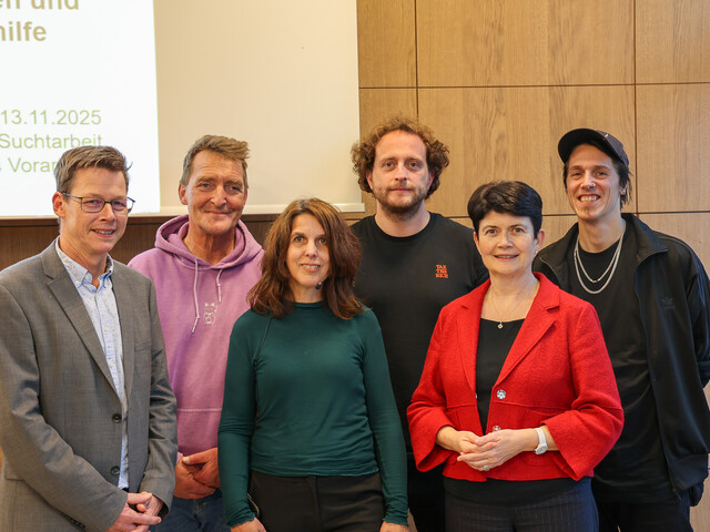 Sechs Personen stehen in zwei Reihen zu einem Gruppenfoto zusammen.